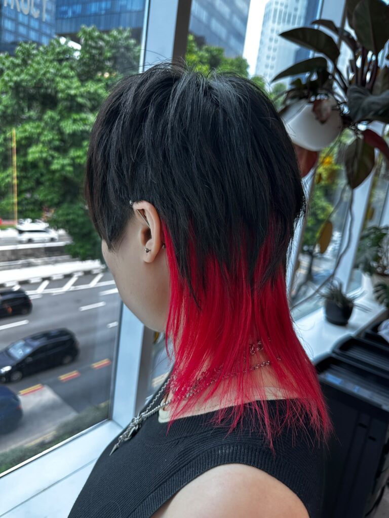 Medium Layer Wolf Cut with Red Inner Bleach Color at Japanese Hair Salon Singapore. Low-damage Plex bleach, red inner color, face-framing wolf haircut.