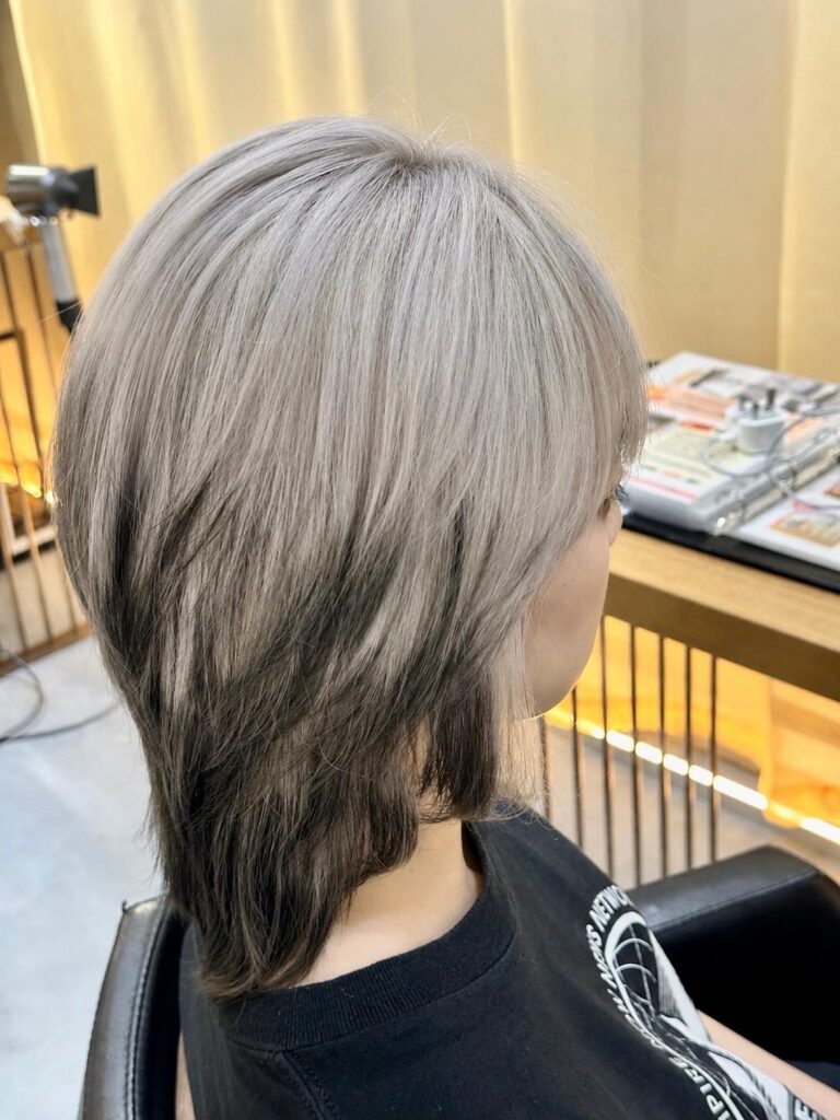 White Bleach Design Color with Medium Layered Wolf Cut in Singapore 1 Medium layered wolf cut with white bleach design color and removable black ends at a Japanese hair salon in Singapore.