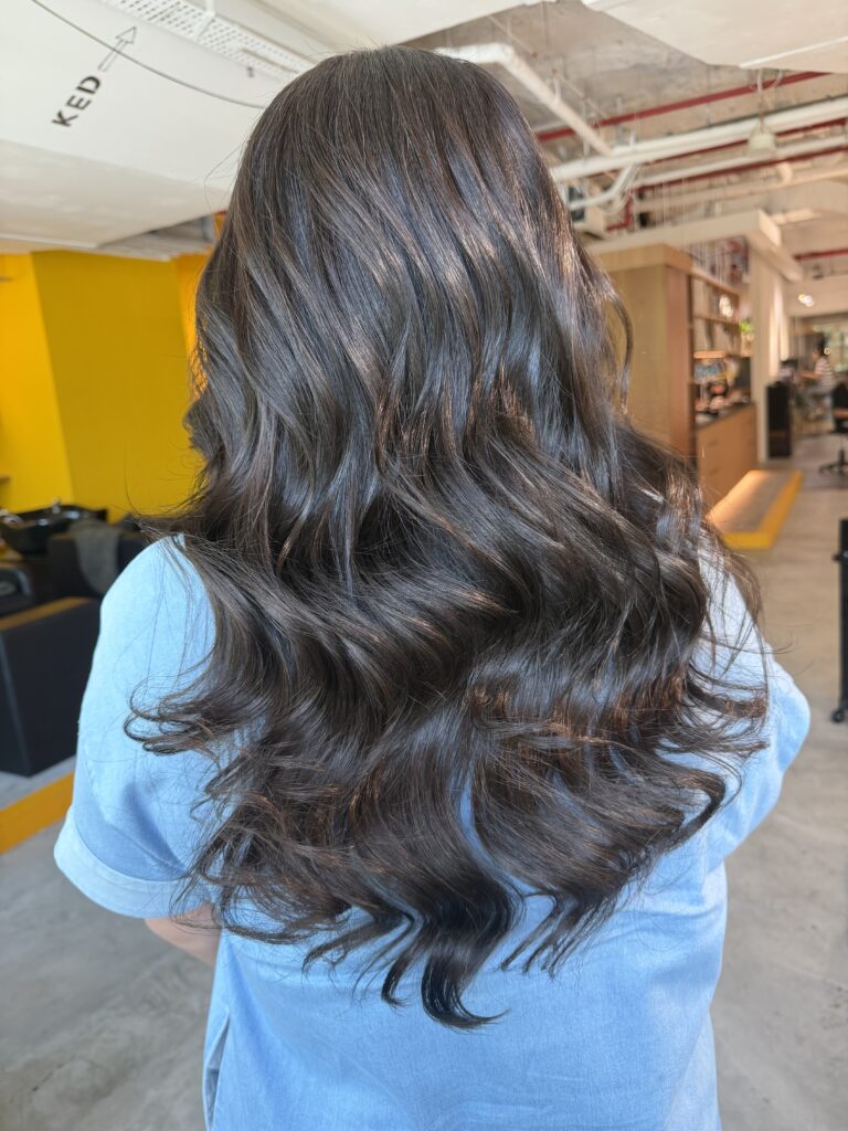 Long Dark Ash Grey Coverage for Long Hair in Singapore 1 Long dark ash grey coverage on long hair with soft low layers and curled styling at a Japanese hair salon in Singapore.