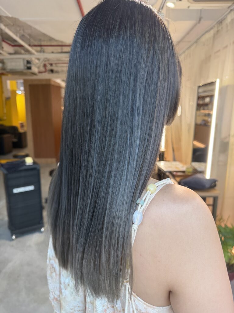 AirTouch Silver Gradient Color Correction for Long Hair in Singapore 1 Long hair transformed from previously red hair into an AirTouch silver gradient color with a dark ash base, hime bangs and a heavy layered-free silhouette at a Japanese hair salon in Singapore.