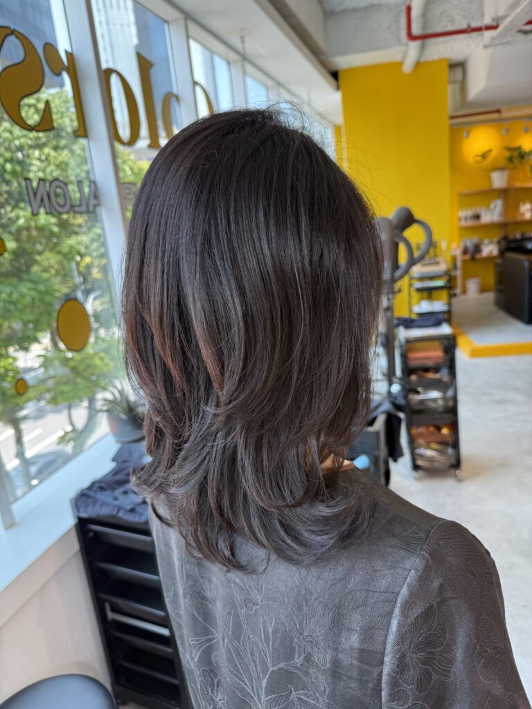 Dark Brown Grey Coverage with Digital Perm for Medium Hair in Singapore 1 Medium layered hair with dark brown grey coverage and a digital perm for soft movement through the ends, created with Plex for a lower-damage finish at a Japanese hair salon in Singapore.