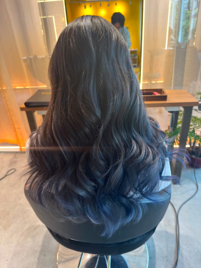 Long bleach AirTouch color with a dark blue to light blue gradient, soft surface layers, and Plex-supported low-damage lightening in Singapore