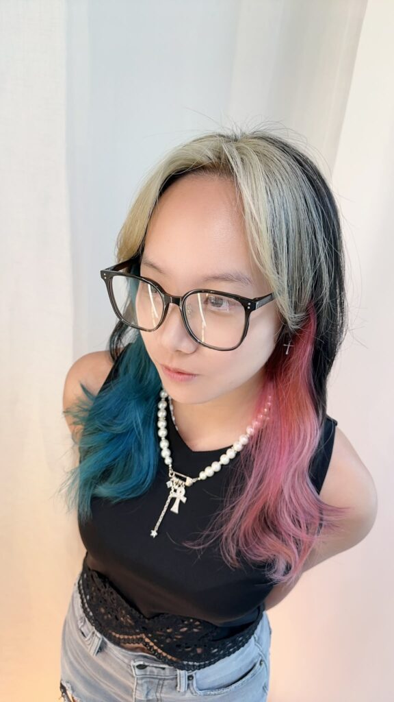 Inner color and face-framing bleach design with blonde face-framing, light pink and turquoise nape accents, and a long layered haircut in Singapore
