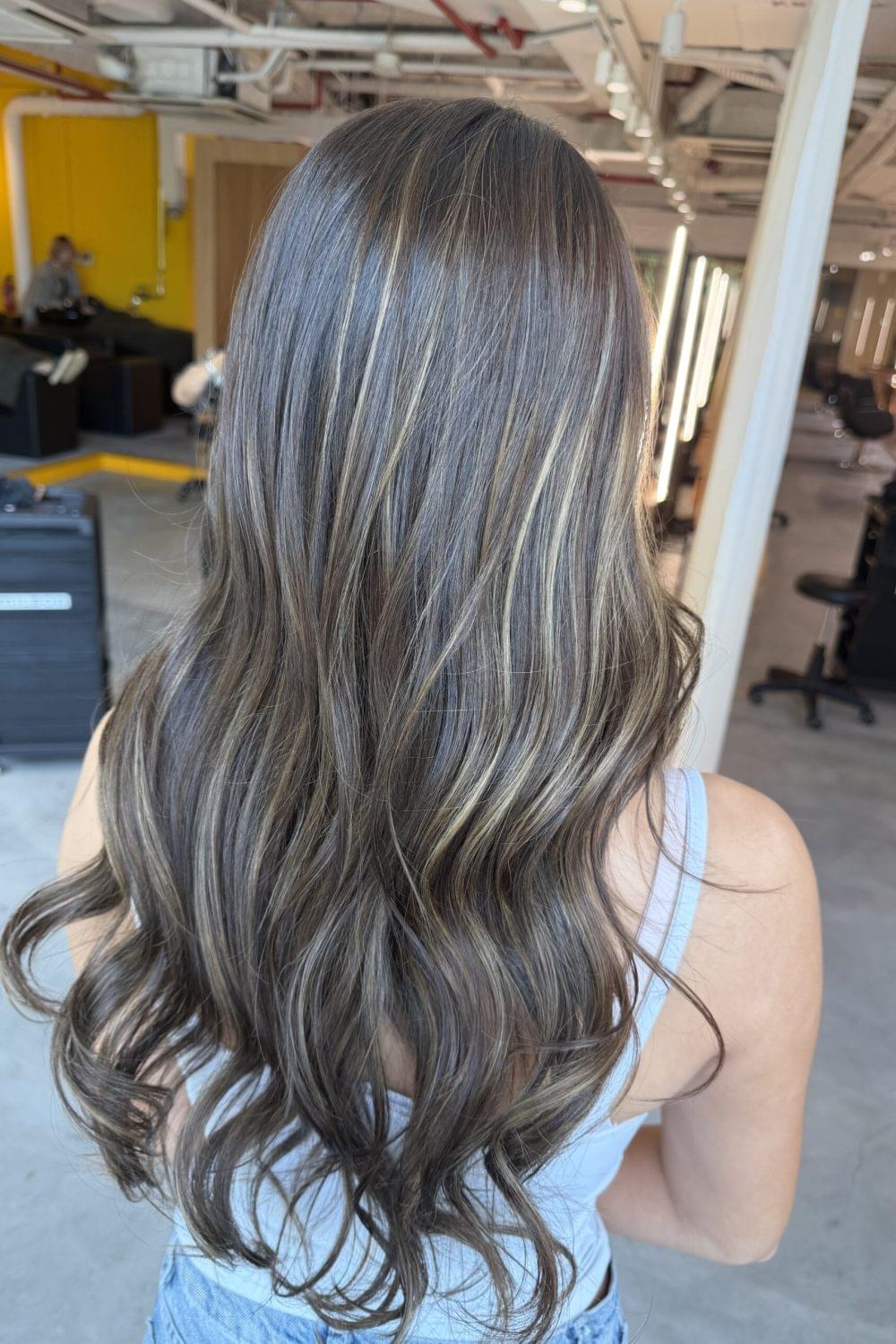 Long bleach highlights with bright beige blonde color and soft natural dimension by Stylist Carmen and Colorist Ura at Colors Japanese Hair Salon Singapore.