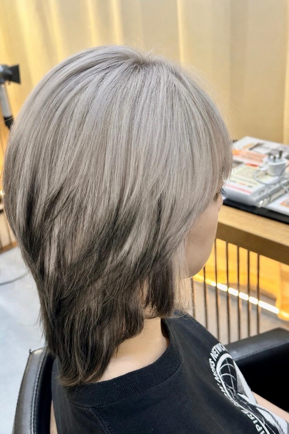 Medium layered wolf cut with white bleach design color and removable black ends at a Japanese hair salon in Singapore.
