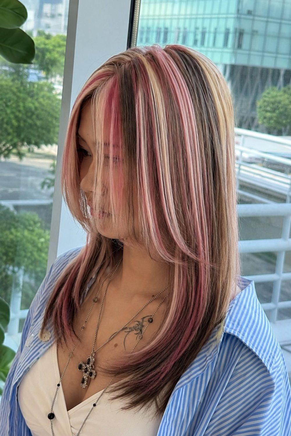 Face framing layered haircut with multi-tone bleach design color featuring pale pink, blonde, and brown tones. Low-damage Plex bleach hair color created at a Japanese Hair Salon Singapore near Clarke Quay and Chinatown.