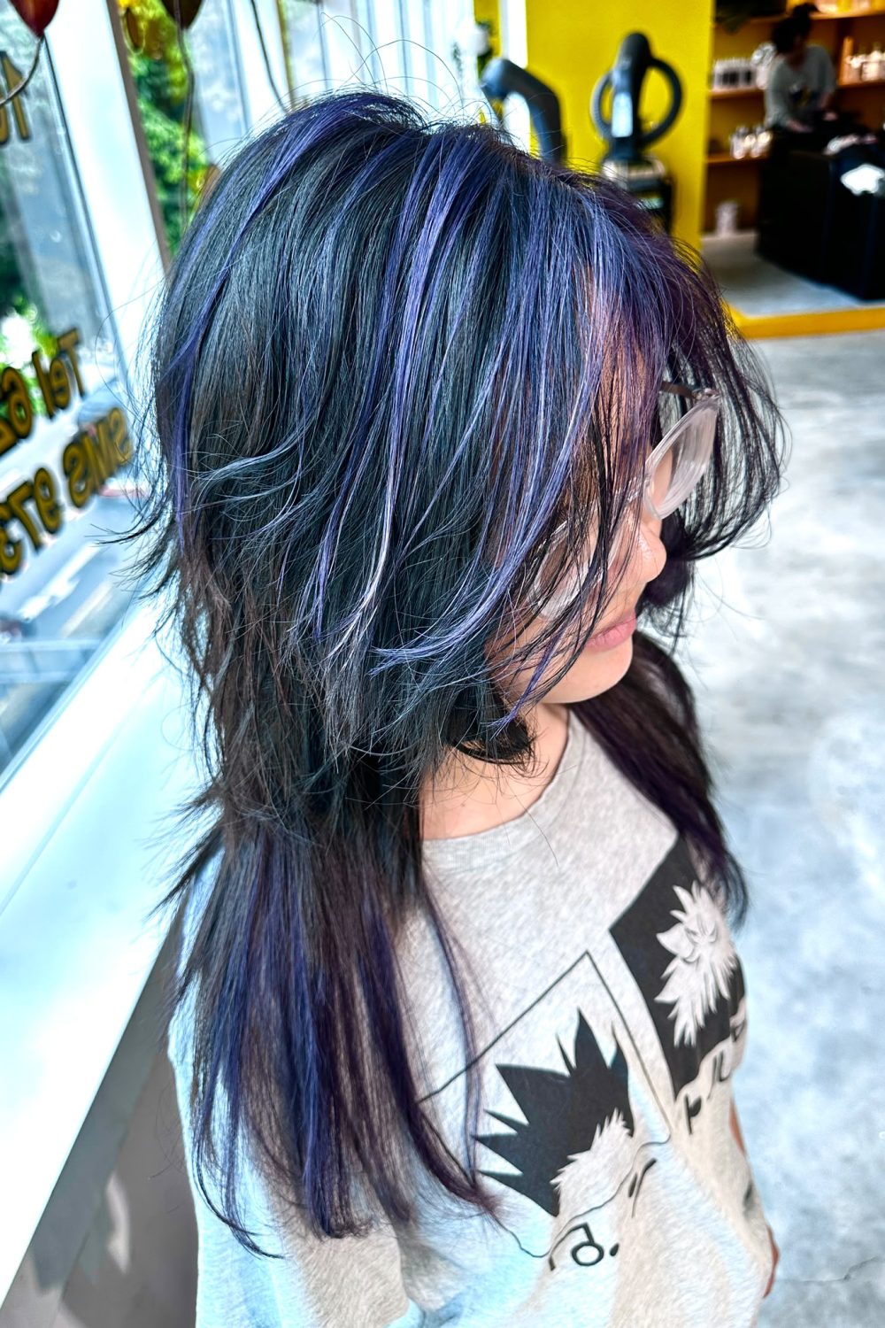 Long high-layer wolf cut with dark purple and bright purple highlights, created with Plex-supported color and bleach for low-damage vivid hair color in Singapore