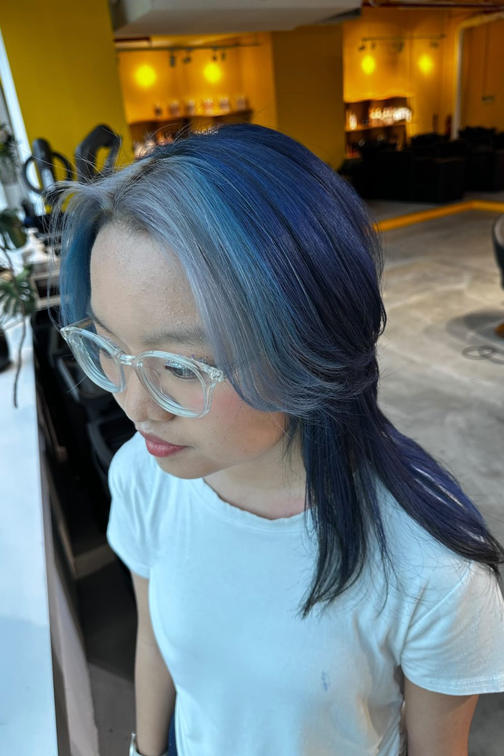 Medium Wolf Cut with face framing blue design color. Full bleach with pale blue face framing and deep blue overall color using Plex technology for low damage at Colors Japanese Hair Salon Singapore.
