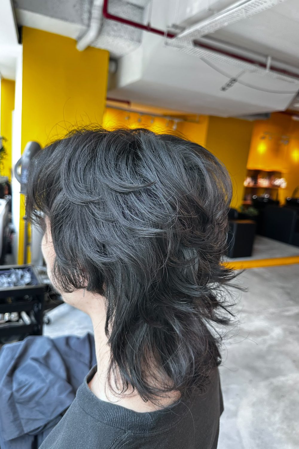 Japanese men’s medium wolf perm at Japanese Hair Salon Singapore. Layered wolf haircut with natural curls, movement, and volume using digital or cold perm techniques