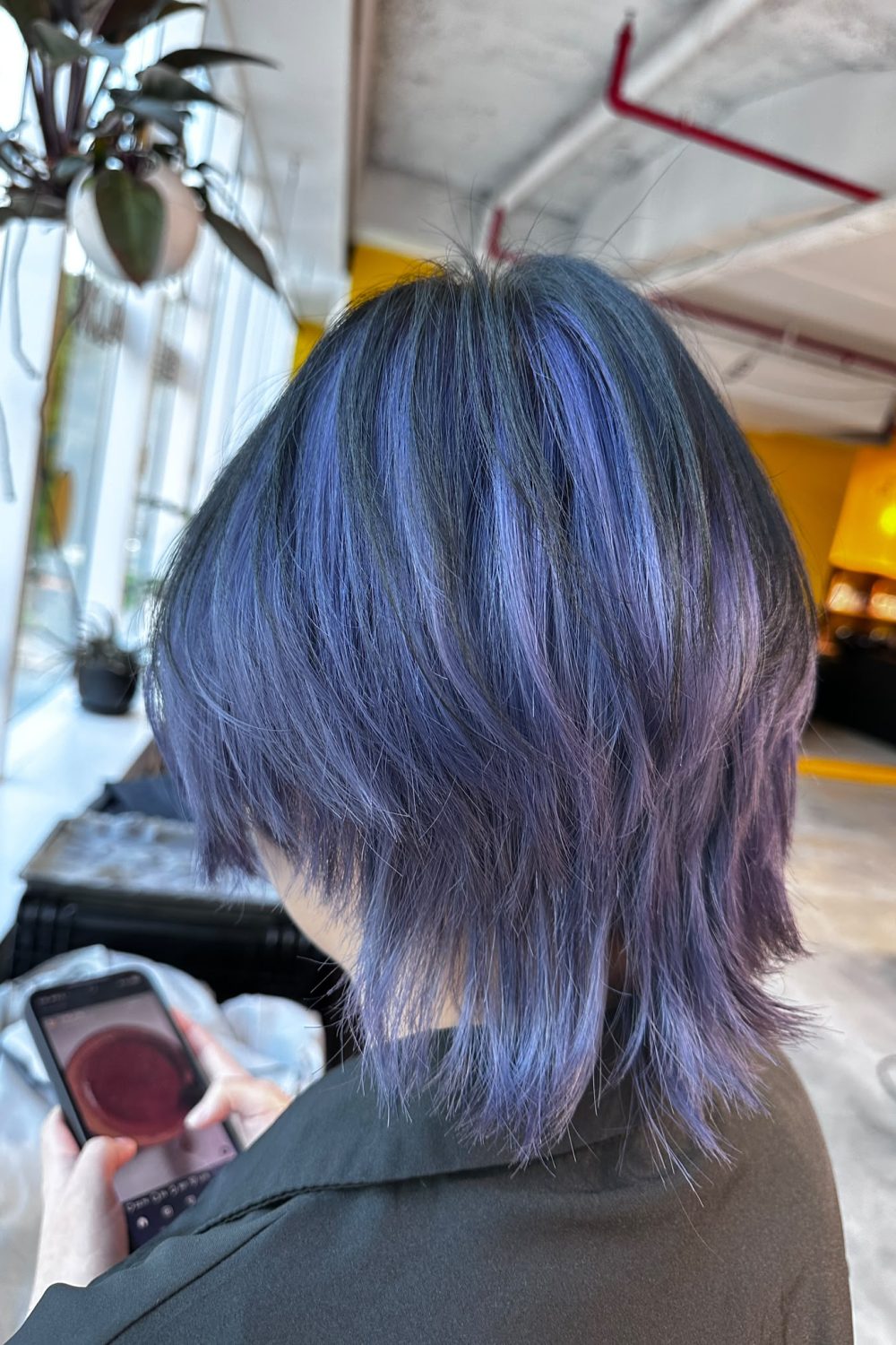 Blue purple full bleach hair color with a medium wolf cut in Singapore, featuring layered volume, face-framing movement, and Plex-supported low-damage bleaching
