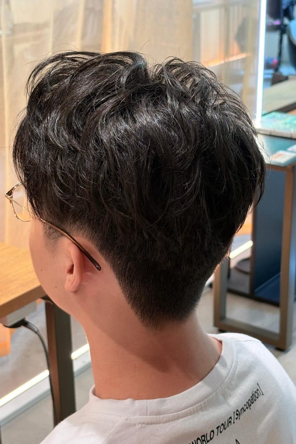 Japanese men’s short haircut with top perm at a Japanese Hair Salon Singapore featuring clean sides and nape with natural volume and texture for busy professionals.
