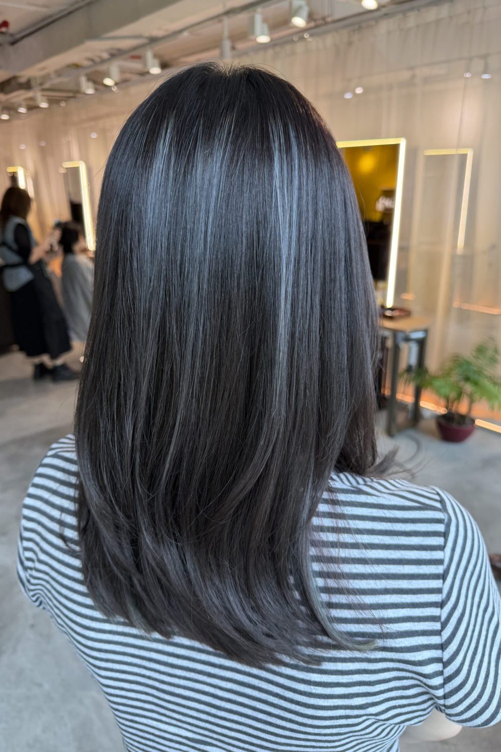 Long low-layer haircut with ash color refresh using Plex Color. Existing highlights were preserved without additional bleach, creating soft dimension and smooth, healthy-looking long hair at Colors Japanese Hair Salon Singapore.