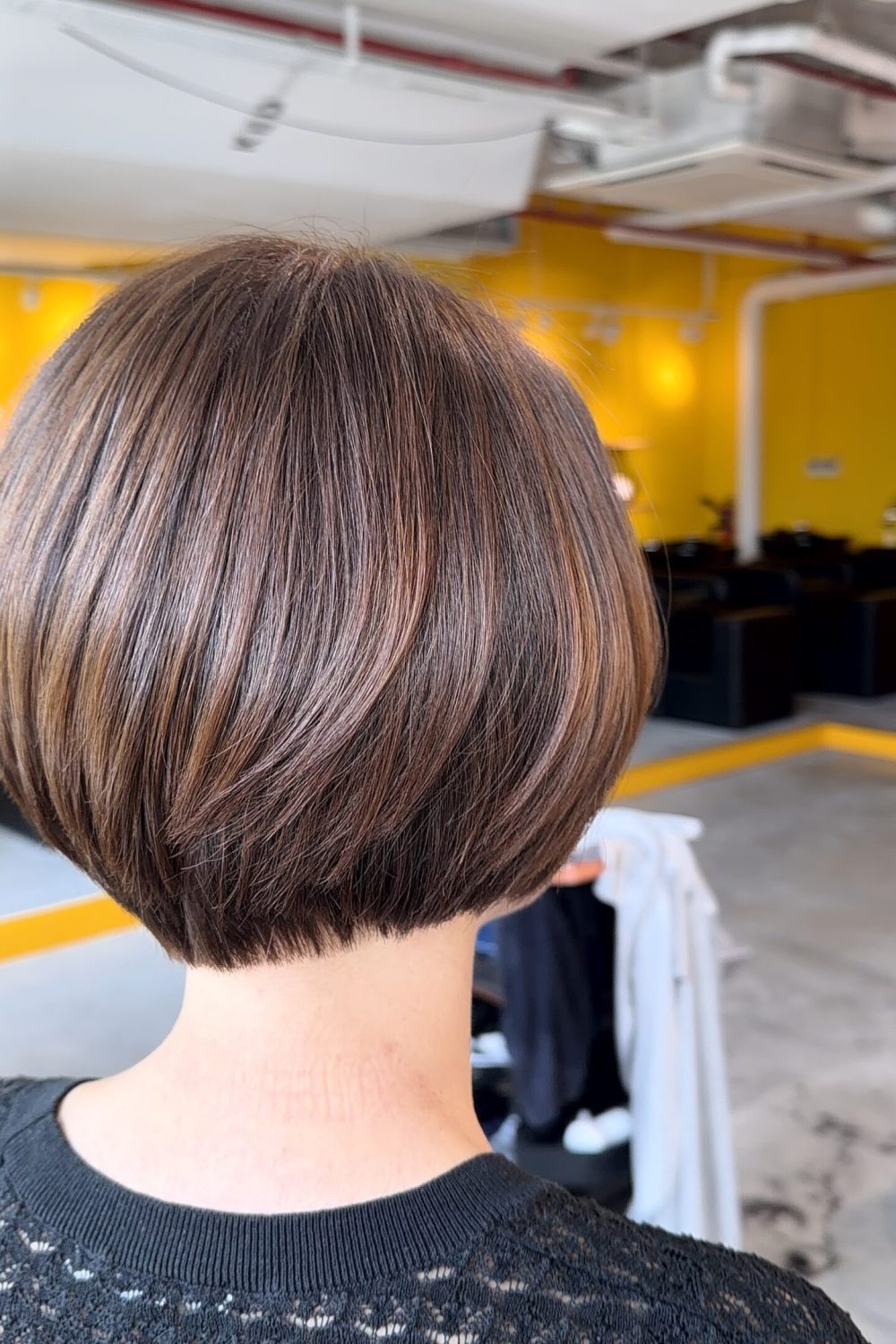A graduated bob haircut with bright beige brown hair color achieved without bleach at a Japanese Hair Salon Singapore. Finished with Plex Color for low damage, creating natural shine, soft movement, and a longer-looking neckline.