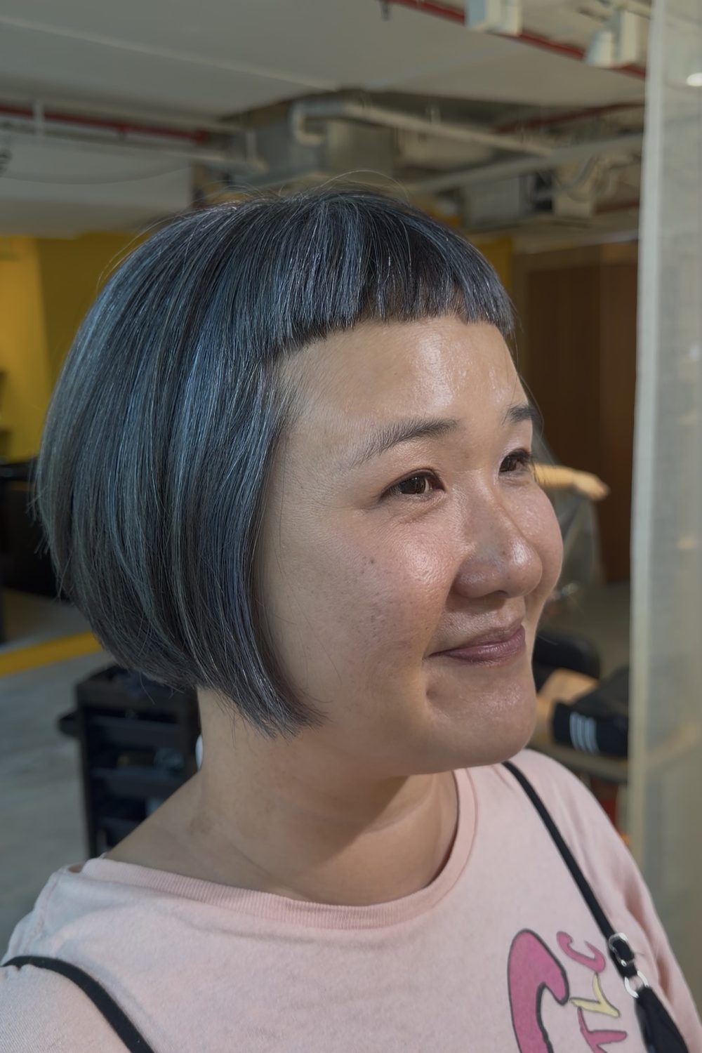 Short grey blending highlights on natural hair with bleach highlights and silver grey toner for a low-maintenance grey hair blending look in Singapore