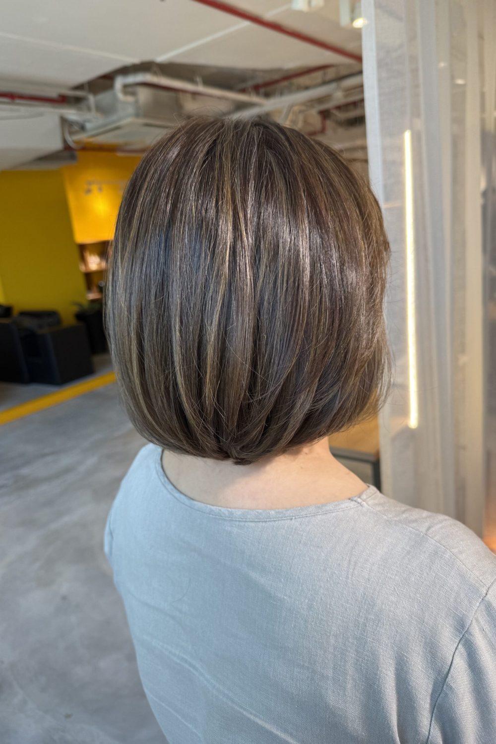 Grey blending beige gold bob hairstyle in Singapore with soft bleach highlights for natural grey hair coverage at a Japanese hair salon.