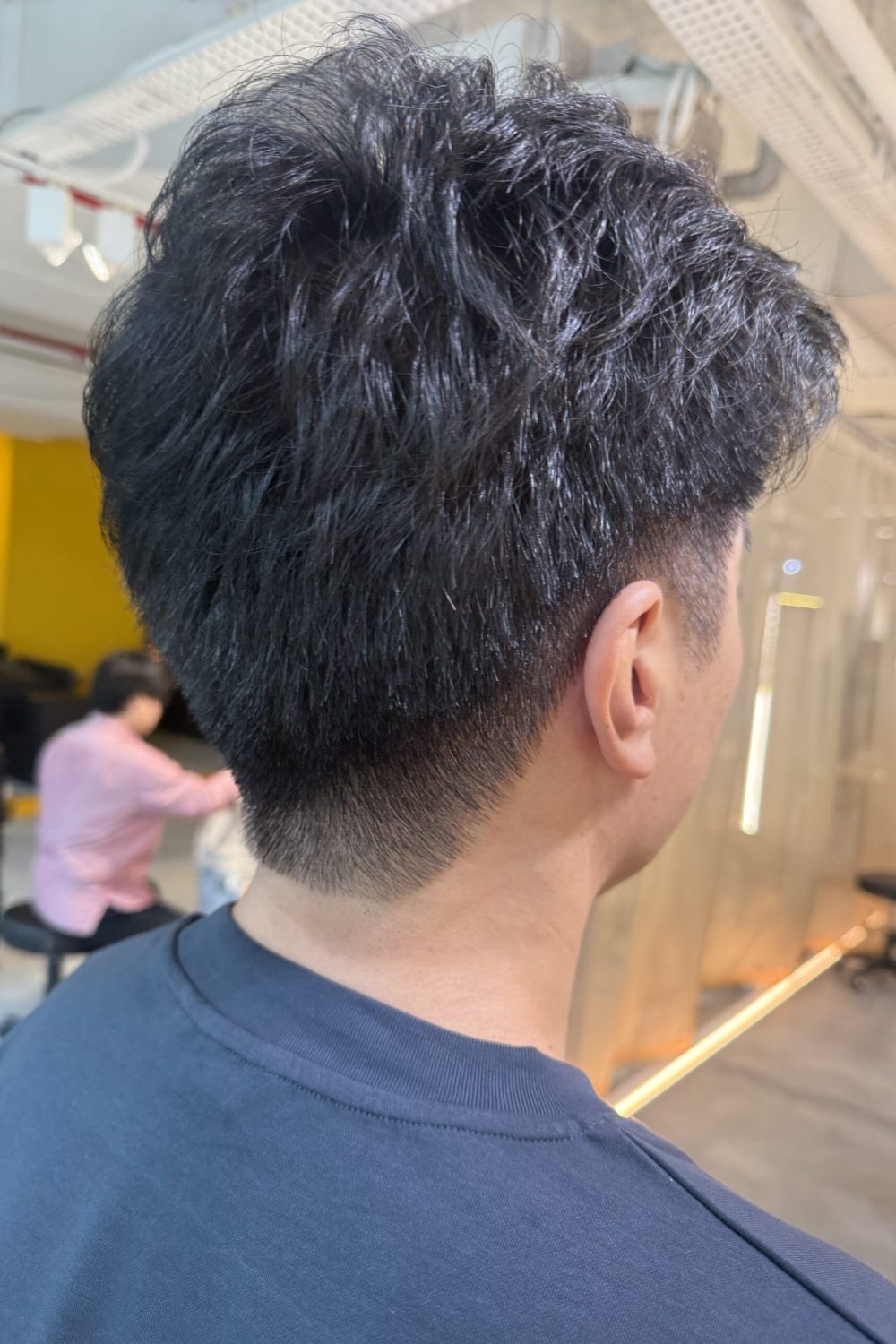 Men’s short fade haircut with dark cool brown grey coverage at Japanese Hair Salon Singapore. Ammonia-free hair color and textured perm for natural business styling.