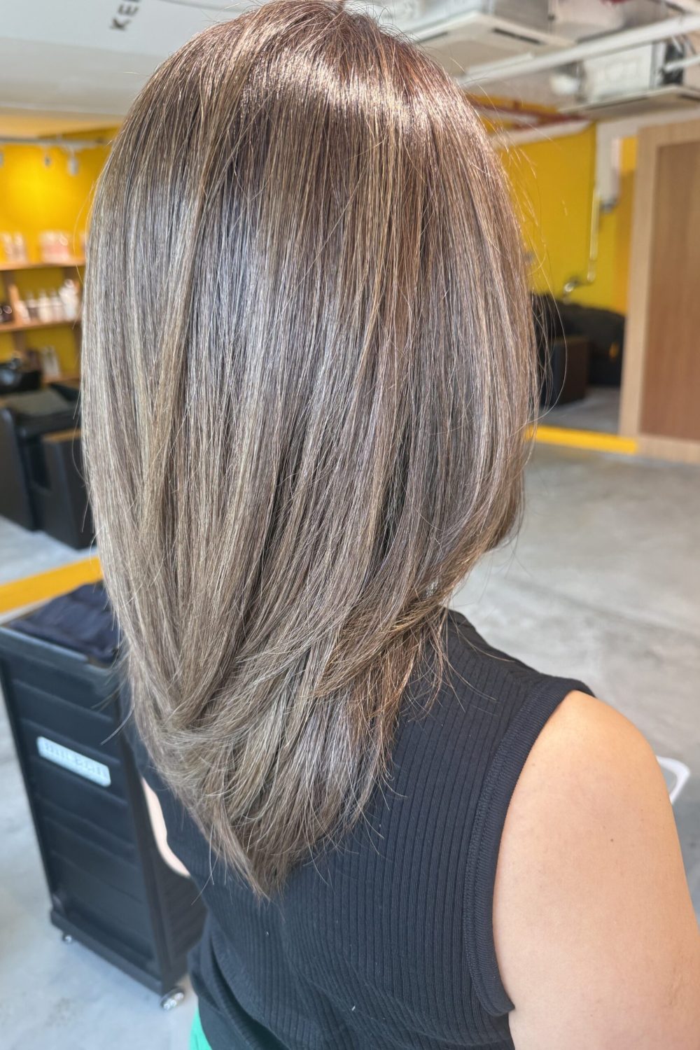 Long layered haircut with bright olive brown grey blending Plex Color at a Japanese Hair Salon Singapore, creating soft movement and natural grey coverage.