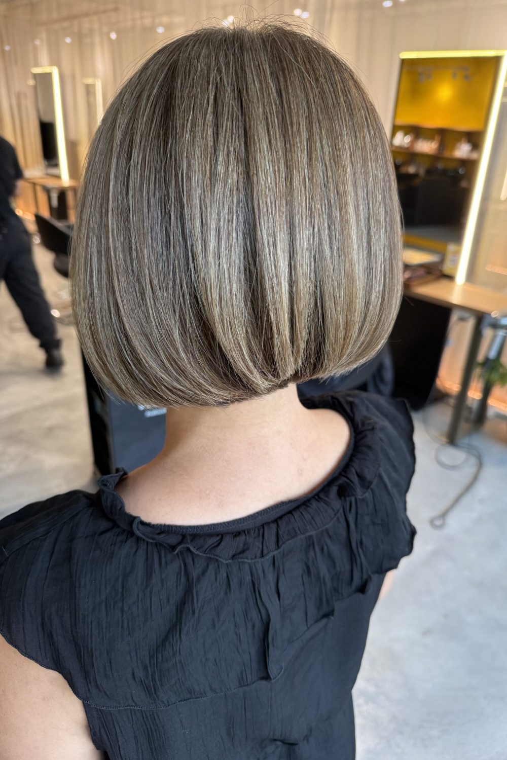 Graduated bob with beige grey coverage color, soft volume and a polished back shape at a Japanese hair salon in Singapore.