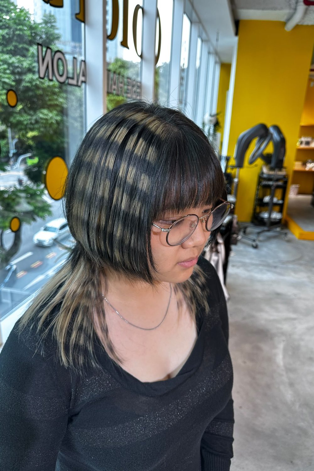 Bangs with Hime Cut and Layered Hair featuring Bleach Design Stripe Color at Japanese Hair Salon Singapore. Face-framing haircut with removable black stripe pattern and creative bleach color.