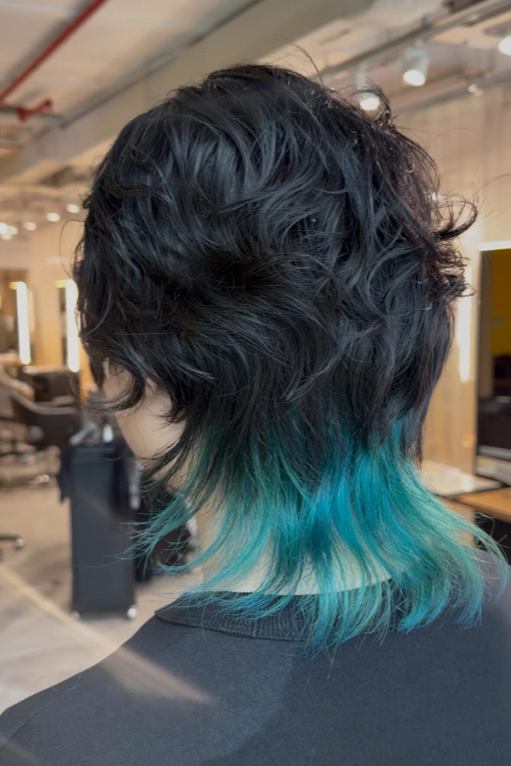 Japanese unisex wolf haircut with textured top perm and emerald green bleach inner color at the nape, created at a Japanese Hair Salon Singapore using low-damage Plex bleach.
